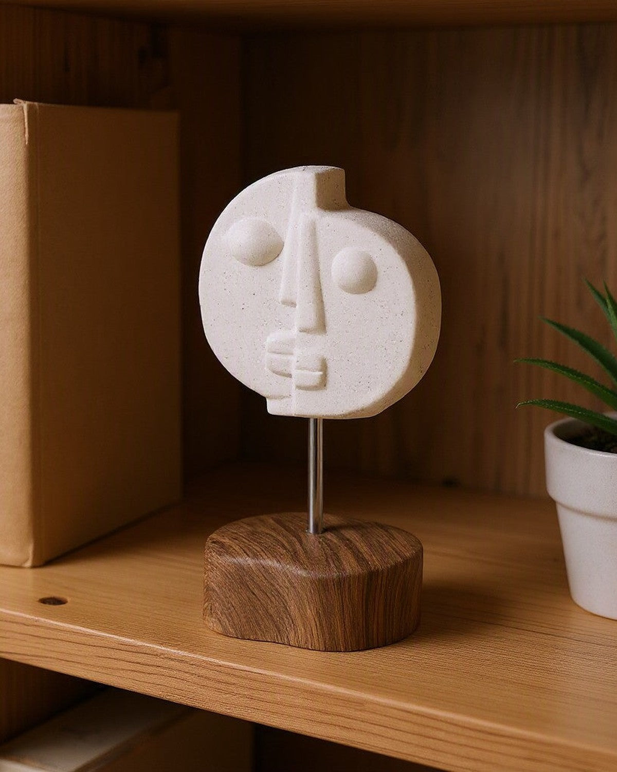 Two-Faced Ceramic Ornament on a shelf