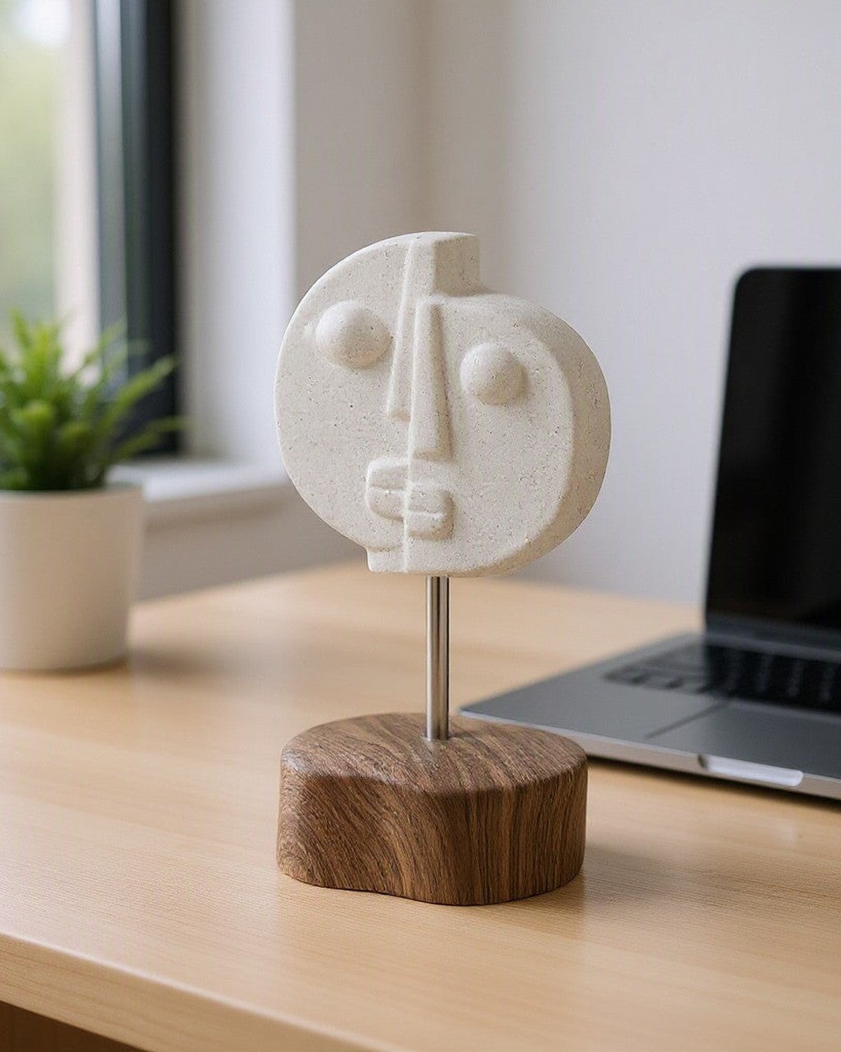 Two-Faced Ceramic Ornament on a desk